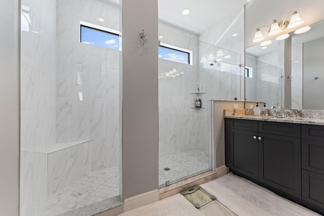 bathroom featuring vanity and tiled shower