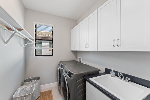 laundry room with separate washer and dryer, sink, and cabinets