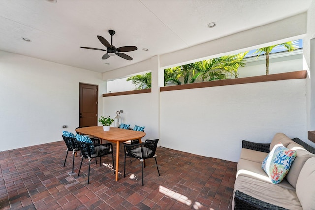 interior space with ceiling fan