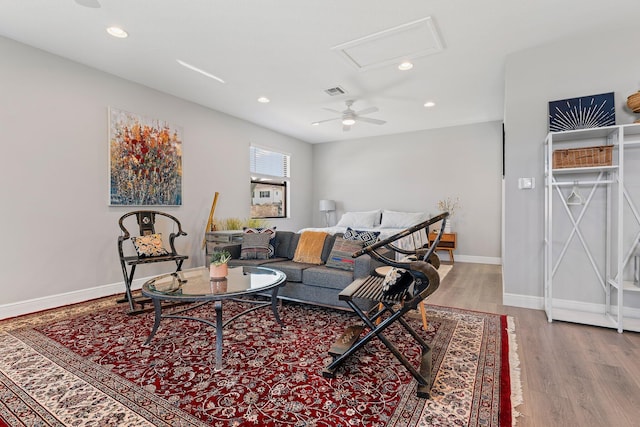 living room featuring ceiling fan and light hardwood / wood-style flooring