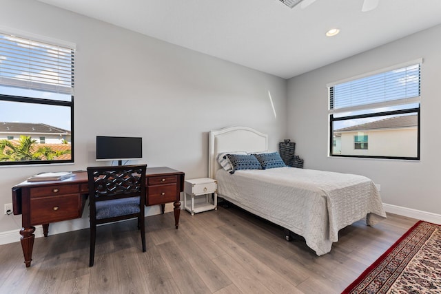 bedroom featuring hardwood / wood-style flooring and multiple windows