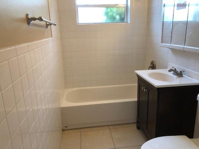 full bathroom with tile patterned floors, vanity, tile walls, and toilet