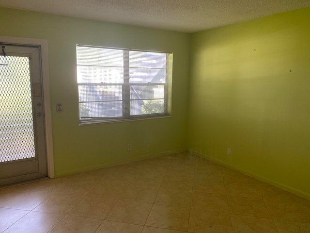 empty room featuring a textured ceiling