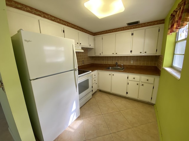 kitchen with tasteful backsplash, white appliances, sink, white cabinetry, and light tile patterned flooring