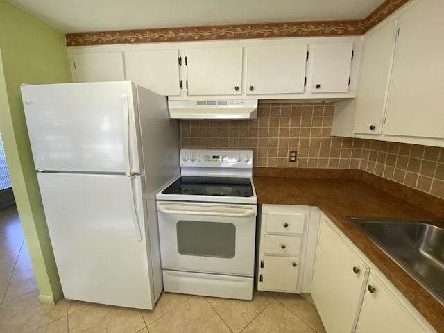 95 Cambridge E Unit 95, West Palm Beach, FL 33417 - kitchen featuring white appliances, under cabinet range hood, light tile patterned flooring, white cabinetry, and dark countertops