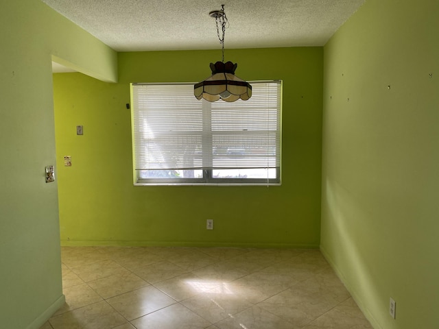 unfurnished dining area with a healthy amount of sunlight and a textured ceiling