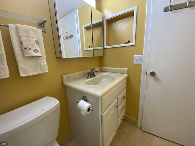 95 Cambridge E Unit 95, West Palm Beach, FL 33417 - bathroom with vanity, toilet, and tile patterned floors