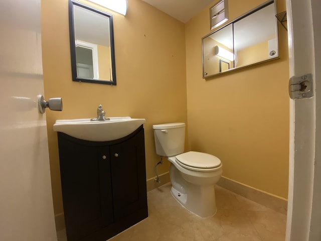 bathroom with tile patterned flooring, vanity, and toilet