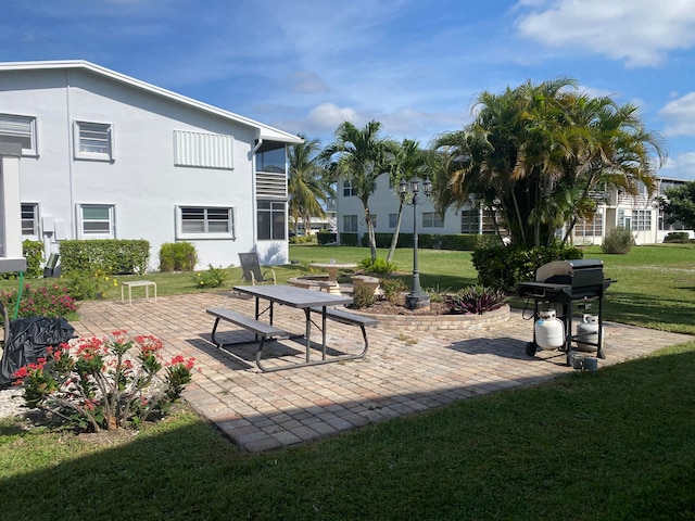 view of community featuring a yard and a patio area