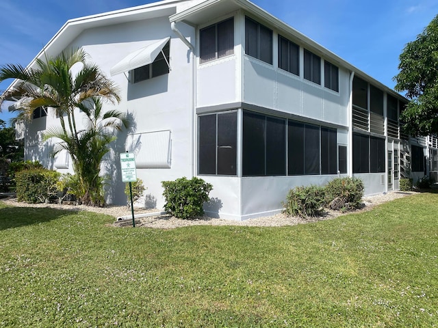 view of side of home with a lawn