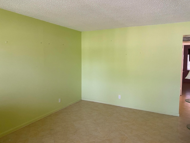 spare room with a textured ceiling