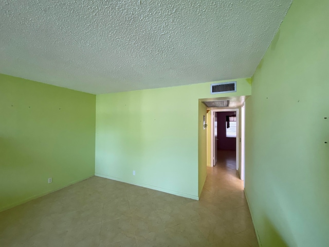 empty room with a textured ceiling