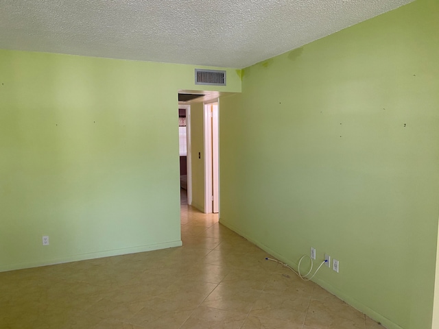 spare room with a textured ceiling