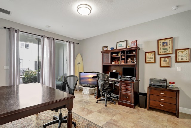 office area with a textured ceiling