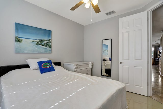 tiled bedroom with ceiling fan