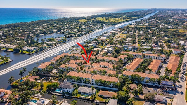 back of property with a fenced in pool, a water view, and a patio