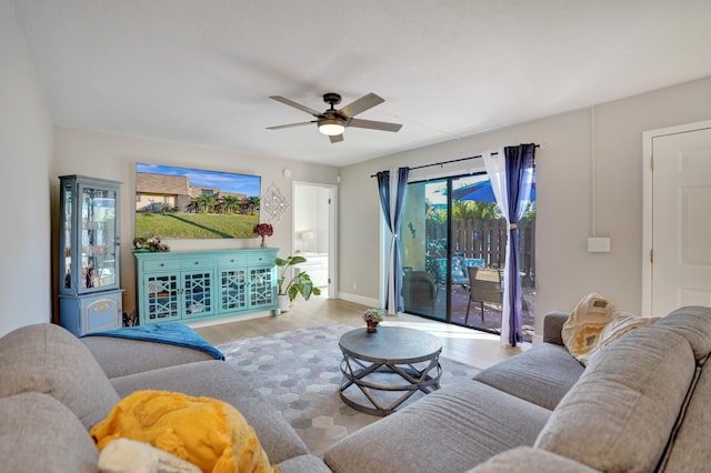 living room with ceiling fan and light wood-type flooring