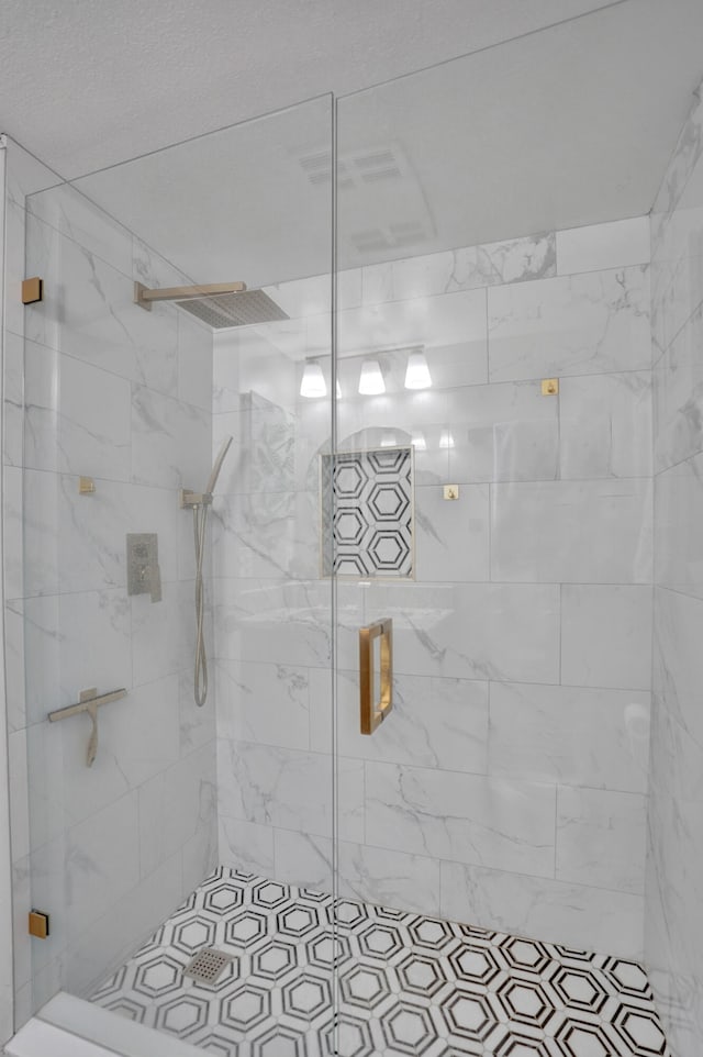 bathroom featuring a shower with door