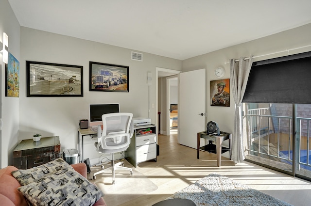 office with light wood-type flooring