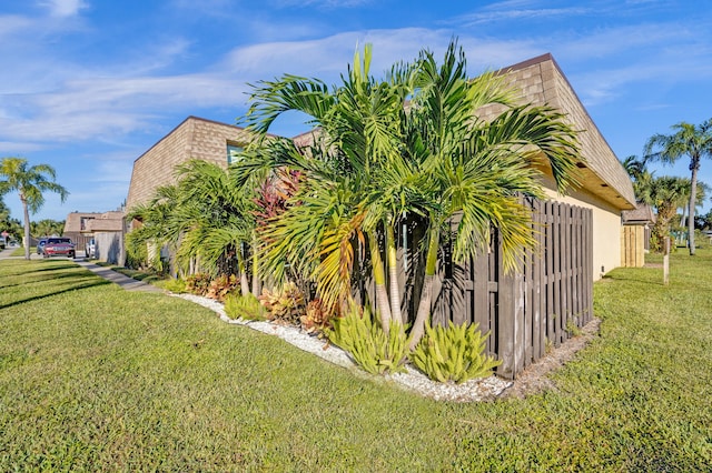 view of side of home with a yard