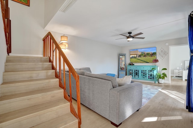 living room with ceiling fan and light hardwood / wood-style flooring