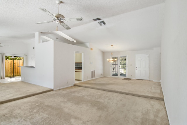 unfurnished living room with a textured ceiling, ceiling fan with notable chandelier, and light colored carpet