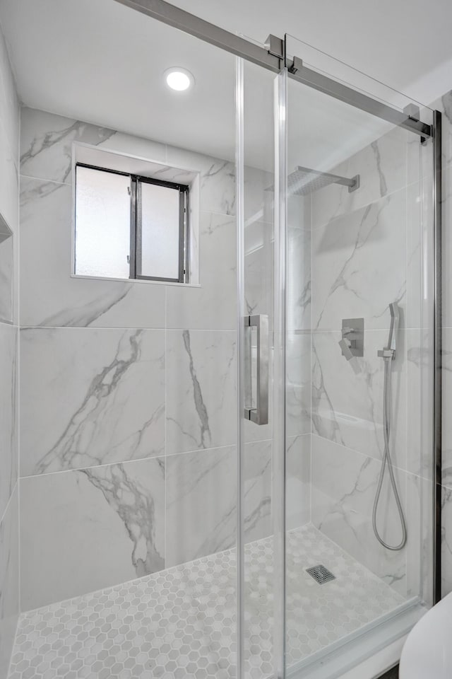 full bath featuring a marble finish shower, recessed lighting, and toilet