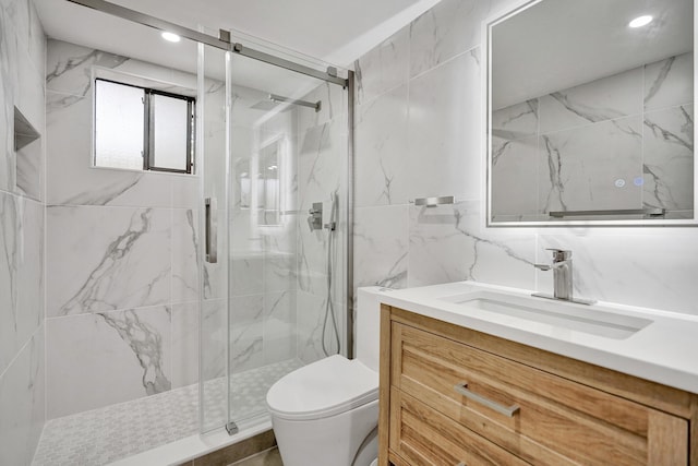 bathroom featuring a marble finish shower, toilet, vanity, recessed lighting, and tile walls