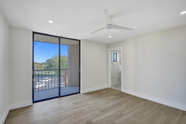 spare room with light hardwood / wood-style floors and ceiling fan