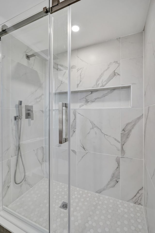 bathroom with a shower with shower door