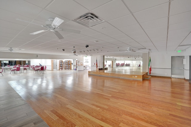 miscellaneous room featuring ceiling fan, a drop ceiling, and light hardwood / wood-style flooring