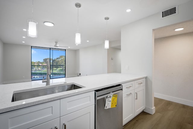 kitchen with stainless steel dishwasher, a sink, white cabinets, wood finished floors, and hanging light fixtures