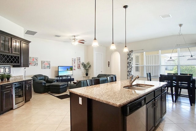 kitchen with a center island with sink, wine cooler, stainless steel dishwasher, ceiling fan, and dark brown cabinets