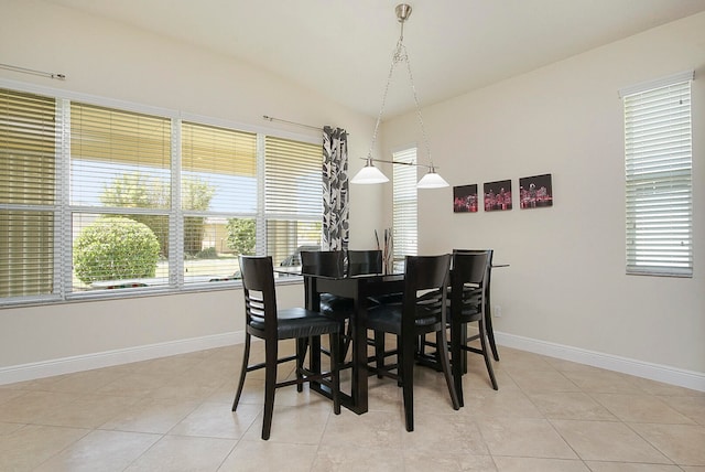 tiled dining area with lofted ceiling