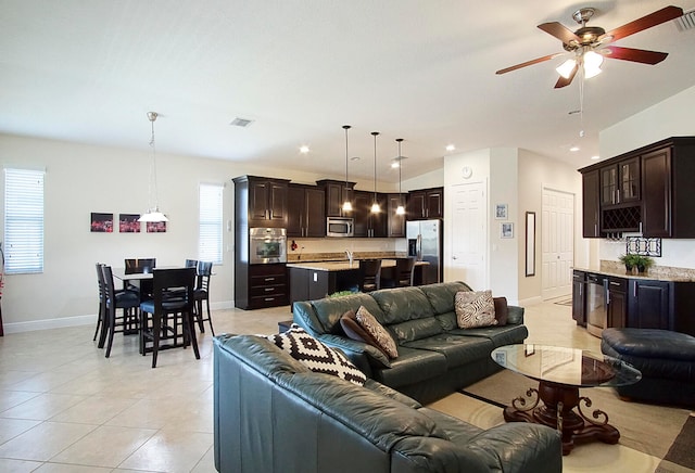 living room with ceiling fan, light tile patterned floors, wine cooler, and lofted ceiling