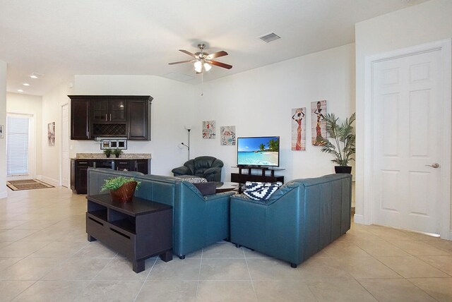 tiled living room with ceiling fan