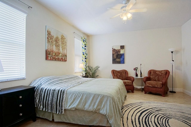 bedroom with ceiling fan and light tile patterned floors