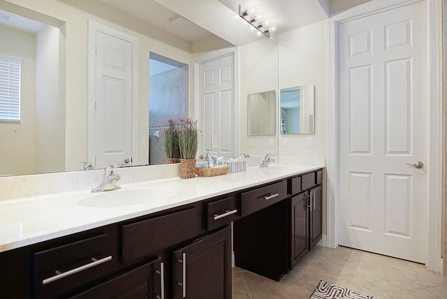 bathroom featuring tile patterned flooring and vanity