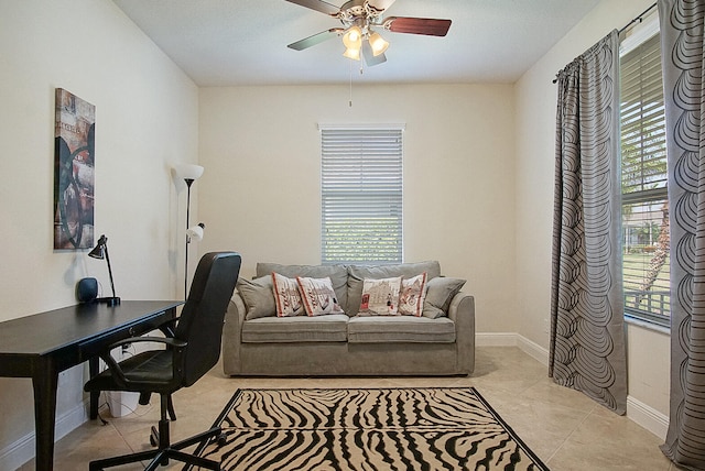 home office featuring ceiling fan, a healthy amount of sunlight, and light tile patterned floors