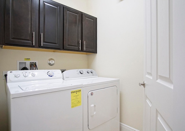 laundry room with cabinets and separate washer and dryer