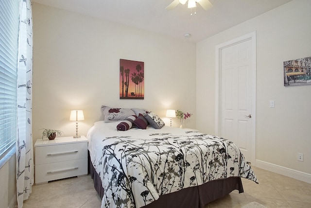 tiled bedroom featuring ceiling fan and a closet