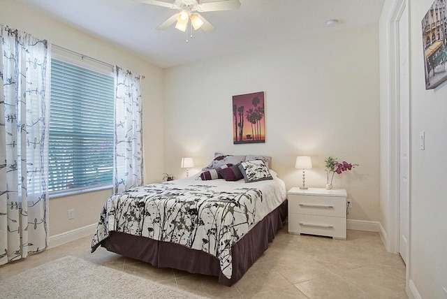 bedroom featuring light tile patterned floors and ceiling fan