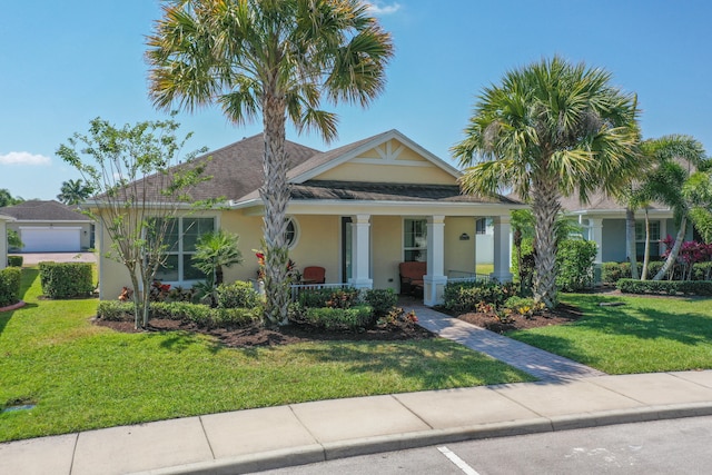 view of front of home featuring covered porch and a front lawn