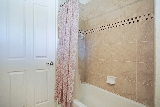 bathroom with shower / bath combo with shower curtain