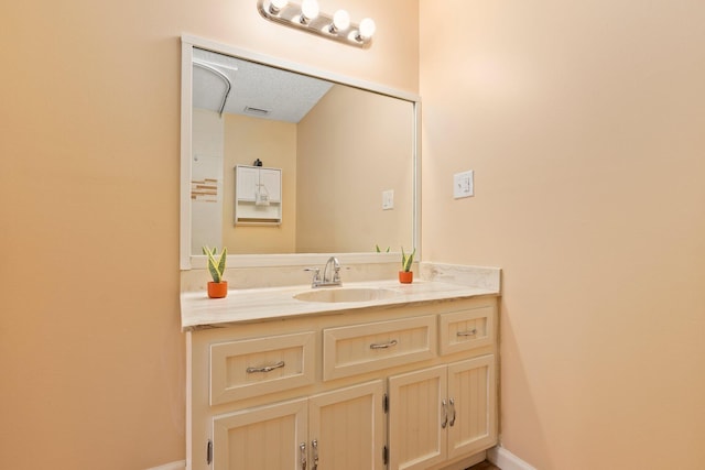 bathroom featuring vanity and a textured ceiling