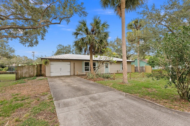 single story home with a garage and a front lawn