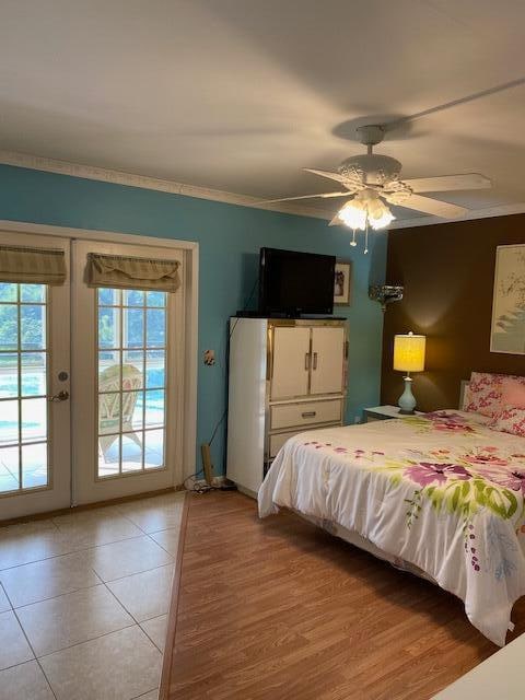 tiled bedroom featuring access to exterior, french doors, ceiling fan, and ornamental molding