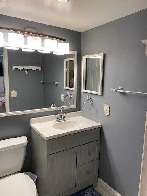 bathroom featuring vanity and toilet