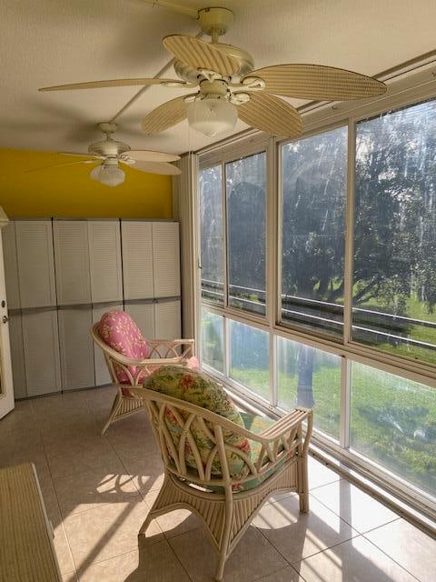 sunroom / solarium with plenty of natural light and ceiling fan