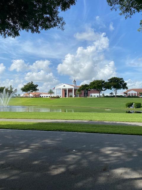 view of home's community featuring a yard and a water view